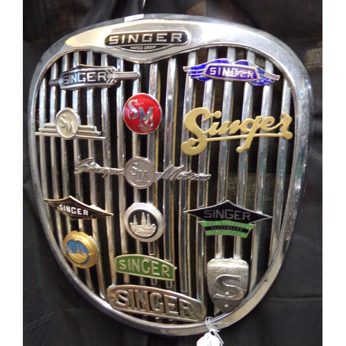 359 - Post War Singer Rootes Group radiator grill mounted with a collection of varied Singer enamel and ot... 