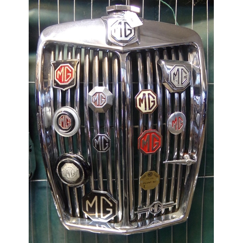 366 - MG Magnette chrome radiator grill set with a variety of different MG octagon shaped and other car ba... 