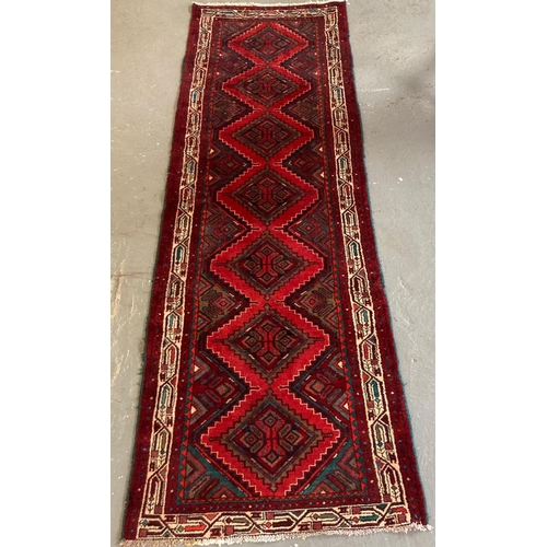 386 - Multi-coloured ground Persian runner with seven repeating lozenge medallions. 
(B.P. 21% + VAT)