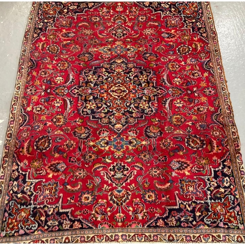 392 - Red ground Persian Mashad floral and foliate carpet. 274 x 192cm approx. 
(B.P. 21% + VAT)