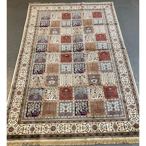 393 - Ivory ground full pile Kashmir carpet with repeating square floral and foliate panels. 306 x 197cm a... 