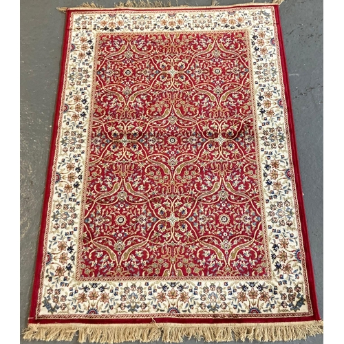 394 - Red ground full pile floral and foliate Kashmir rug. 170 x 120cm approx.
(B.P. 21% + VAT)