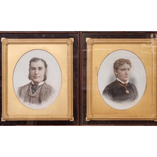 67 - Pair of late Victorian overpainted photographic portraits on opaline glass, gentleman and lady, with... 