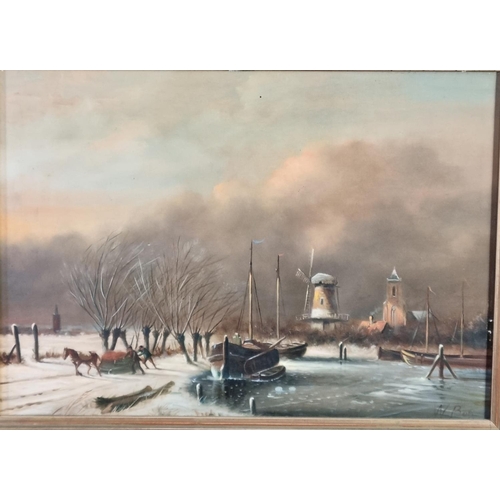 73 - Dutch School (19th century, signed W Bos), Winter scene with moored Dutch barges, windmill, village ... 