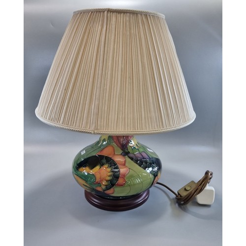 157 - Modern Moorcroft tube-lined Carp design table lamp, of baluster form, standing on a wooden base.  Th... 