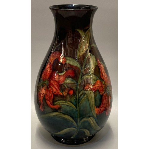 150 - Mid century Moorcroft pottery tube lined 'Hibiscus' vase, on a green graduated ground, of baluster f...