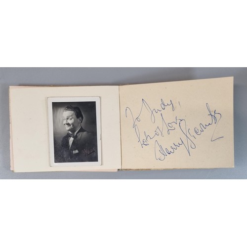 129 - Mid century autograph book containing various autographs and autographed photographs, particularly f... 