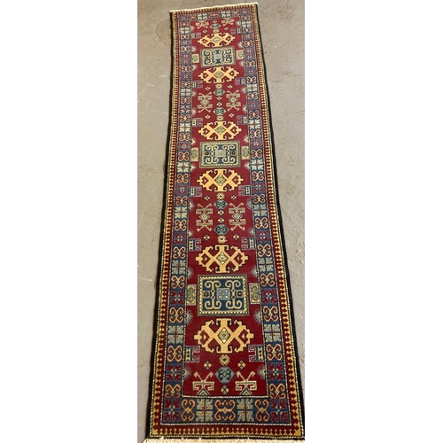 384 - Fine woven multi-coloured ground Caucasian runner with geometric repeating designs. 324 x 73cm appro... 