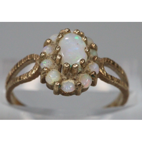 253 - 9ct gold opal cluster dress ring.  Size K1/2.  1.8g approx.  (B.P. 21% + VAT)