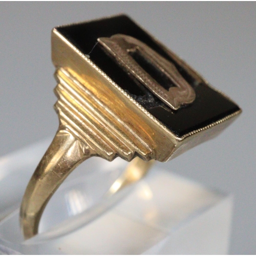 259 - 9ct gold signet ring with black hard stone and initial 'D'.  size R.  3.5g approx.  (B.P. 21% + VAT)