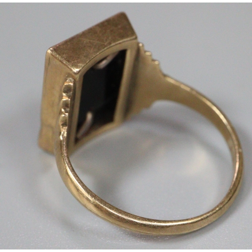 259 - 9ct gold signet ring with black hard stone and initial 'D'.  size R.  3.5g approx.  (B.P. 21% + VAT)