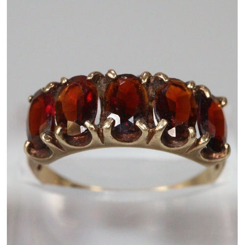 264 - 9ct gold red five stone dress ring.  Size N.  2.3g approx.  (B.P. 21% + VAT)