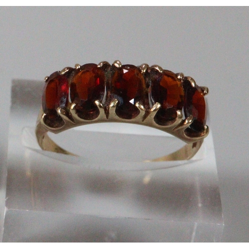 264 - 9ct gold red five stone dress ring.  Size N.  2.3g approx.  (B.P. 21% + VAT)