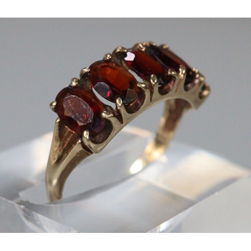 264 - 9ct gold red five stone dress ring.  Size N.  2.3g approx.  (B.P. 21% + VAT)