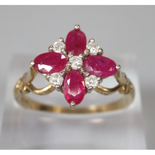 268 - 9ct gold white and red stone flowerhead ring.  Size O1/2.  2.9g approx.  (B.P. 21% + VAT)