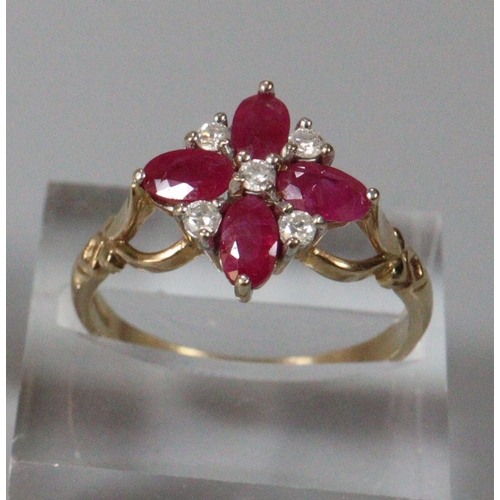 268 - 9ct gold white and red stone flowerhead ring.  Size O1/2.  2.9g approx.  (B.P. 21% + VAT)