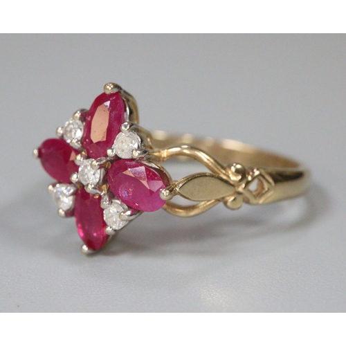 268 - 9ct gold white and red stone flowerhead ring.  Size O1/2.  2.9g approx.  (B.P. 21% + VAT)