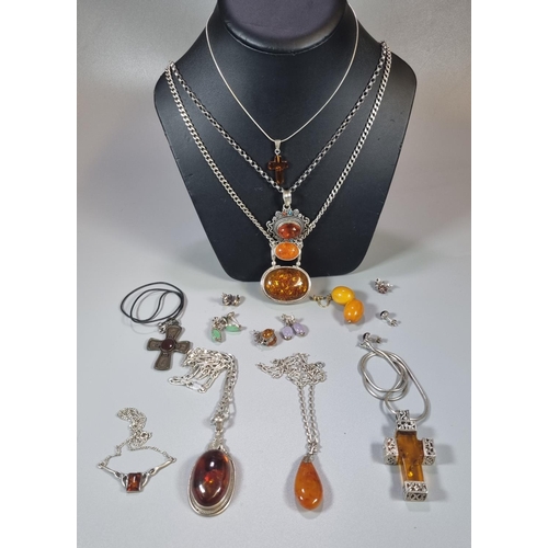 292 - Collection of continental silver and amber jewellery, to include: pendants on chains, Amber cross et... 