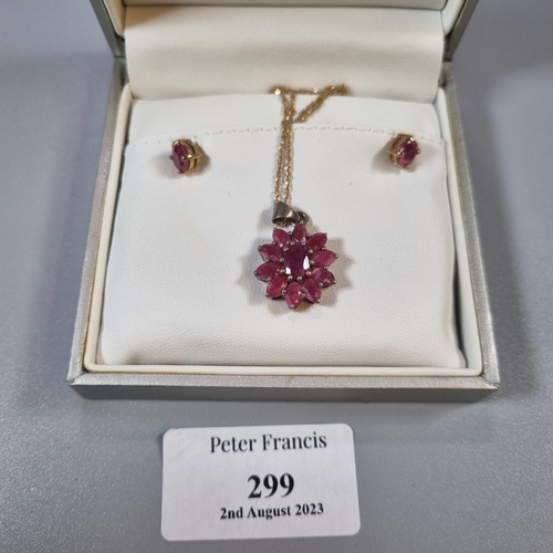 299 - Pair of 9ct gold ruby earrings together with a 9ct gold and red stone flowerhead pendant and chain. ... 