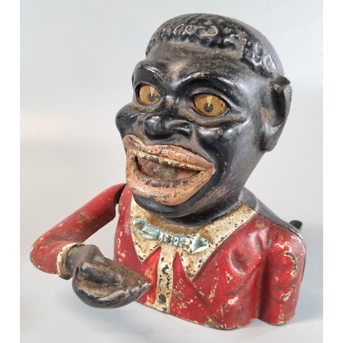 35 - Cast iron black man money box.
These items are listed on the basis they are illustrative of a bygone... 