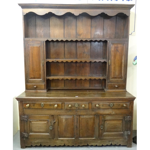 571 - Part 18th century oak rack back dresser, the moulded cornice above carved frieze with boarded rack, ... 