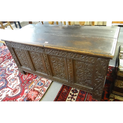 587 - 18th century oak coffer, the moulded top with hinged iron mounts above a later ornately carved folia... 