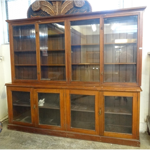 596 - Edwardian glazed library bookcase, the recessed top with four glazed doors revealing adjustable shel...
