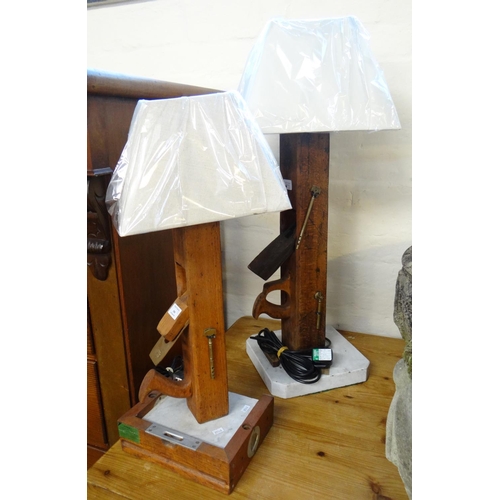 599 - Two similar novelty wooden table lamps formed from vintage block planes, with marble bases and linen... 