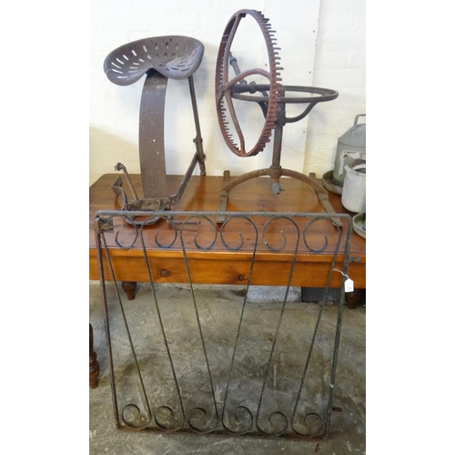 606 - Agricultural bygones to include: vintage tractor seat, vintage cast iron water sprinkler and a wroug... 