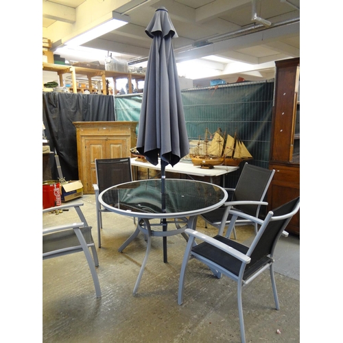 618 - Modern metal and fabric garden set with circular glass table, four armchairs and a parasol.  (B.P. 2... 