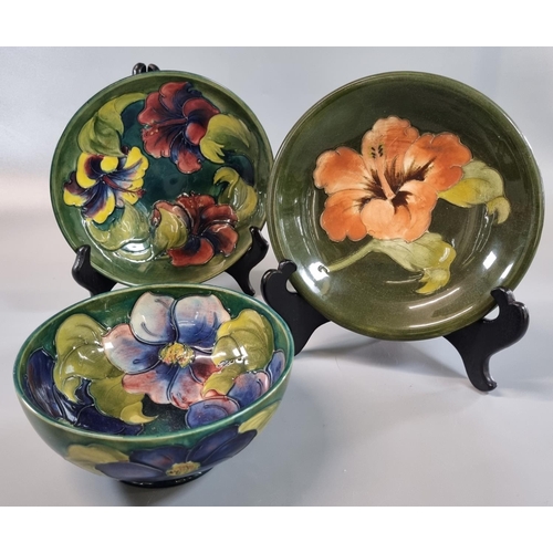 9 - Collection of Moorcroft pottery Hibiscus design tube lined items to include: two shallow bowls and a... 