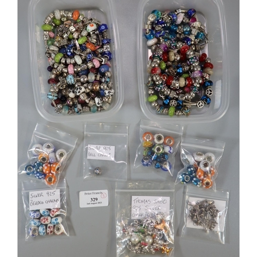 329 - Three plastic containers comprising charm bracelets and charms, Murano style beads, some silver char... 