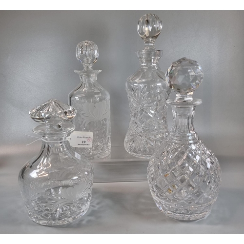 19 - Group of four cut lead crystal decanters of different designs: hobnail cut,  star cut, foliate etche... 