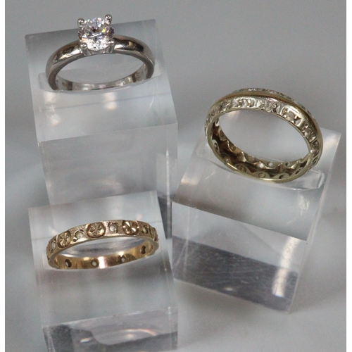 205 - 9ct gold engraved eternity style ring, another similar unmarked, a 9ct white gold solitaire ring.   ... 