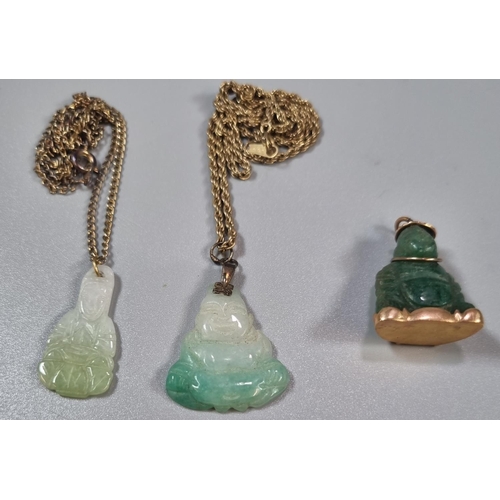 217 - Two jade pendants on chains and another similar yellow metal mounded in the form of a Buddha.  (3)  ... 