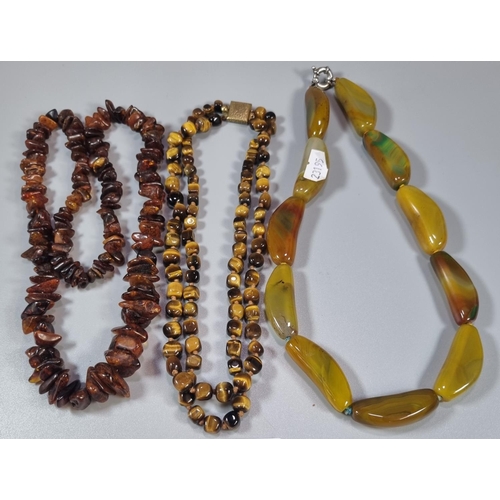 222 - Three hardstone necklaces to include tiger's eye and others.  (B.P. 21% + VAT)