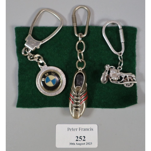 252 - Three silver hallmarked keyrings including: football boot, motorbike with BMW logo.