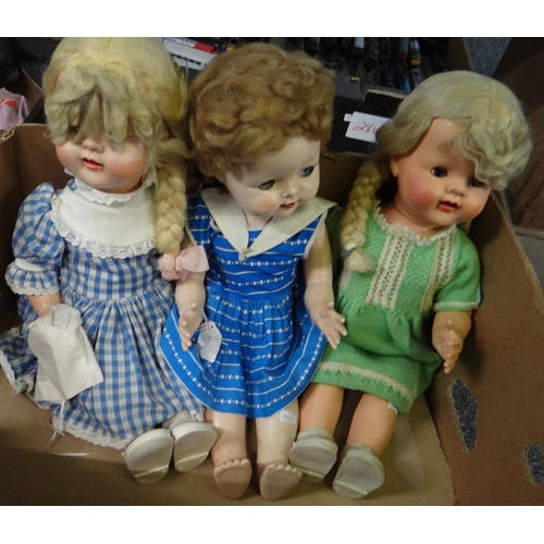 269 - Three plastic children's dolls with moveable eyes and limbs in fabric clothing: one in woolen knitte... 