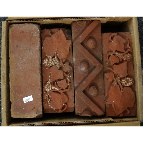 277 - Box containing four Victorian bricks, three with moulded design; two vine leaf and grape and one zig... 