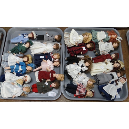 317 - Two trays of small porcelain dolls, in vintage clothing; Victorian to mid 20th Century.  (2) 
(B.P. ... 