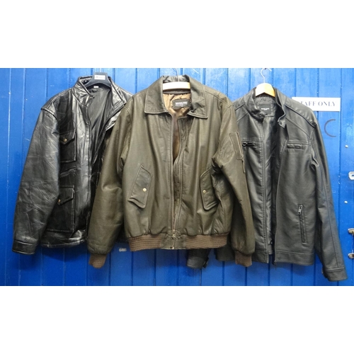 415 - Three men's leather and pleather bomber jackets with pockets, one by Woodland leather, all three siz... 