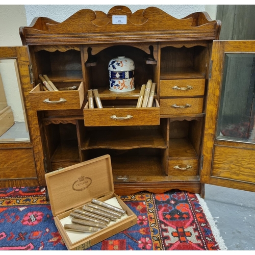 436 - Large early 20th century oak two door glazed smoker's cabinet.   (B.P. 21% + VAT)