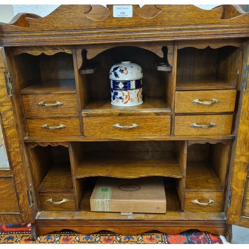 436 - Large early 20th century oak two door glazed smoker's cabinet.   (B.P. 21% + VAT)