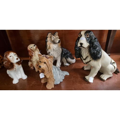 87 - Group of assorted ceramic dogs to include: Beswick 2377 Terrier, Sylvac Spaniel, another Spaniel, la... 