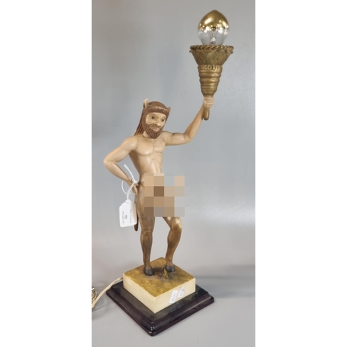 92 - Slightly alarming novelty table lamp in the form of a well endowed Satyr figure supporting flaming t... 