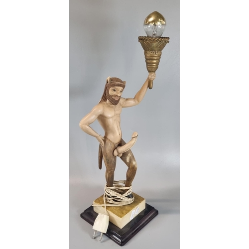 92 - Slightly alarming novelty table lamp in the form of a well endowed Satyr figure supporting flaming t... 