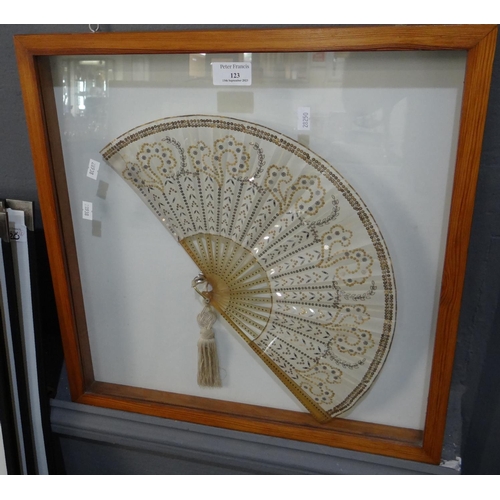 123 - Framed and glazed decorative fan with applied sequin decoration and tassel.  (B.P. 21% + VAT)