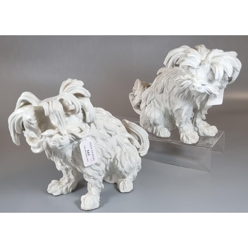 161 - Pair of continental porcelain Blanc de Chine seated fireside dogs, blue mark to the underside.  (2) ... 