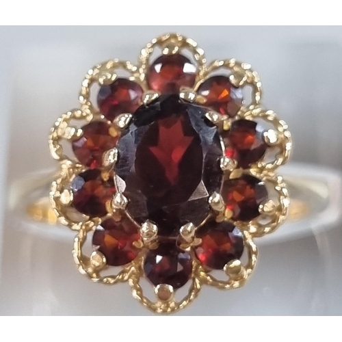 205 - 9ct gold and ruby flowerhead cluster ring.  4.2g approx.  Size O1/2.  (B.P. 21% + VAT)