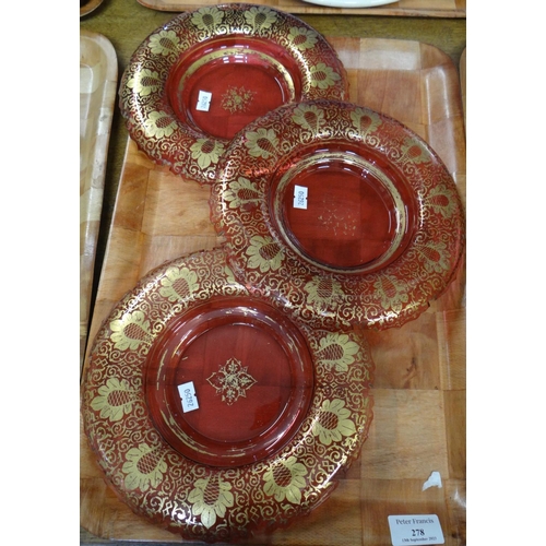 278 - A set of three 19th Century cranberry glass gilt design dessert dishes, possibly Bohemian. 
(B.P. 21... 